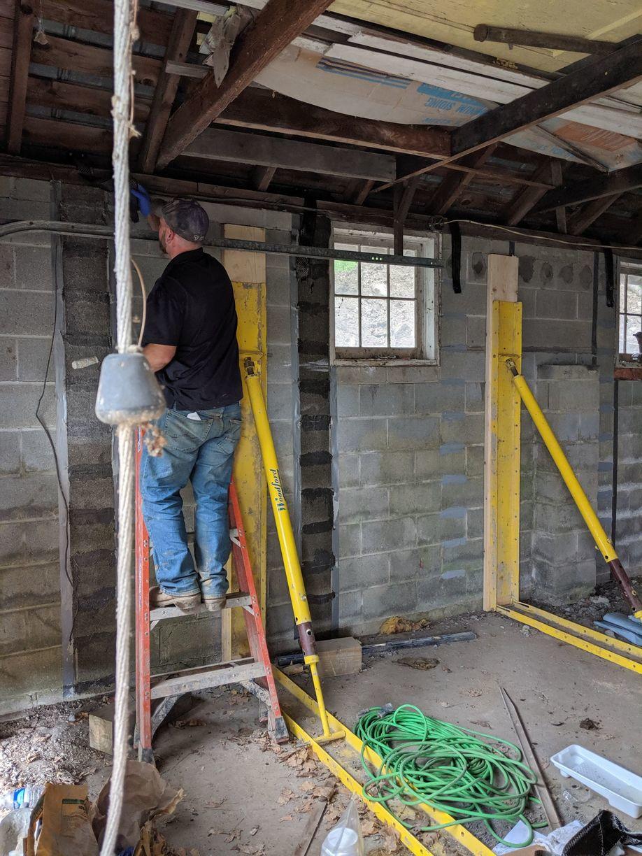 Foundation Repair Woodford Wall Pushing System WWPS next to Carbon