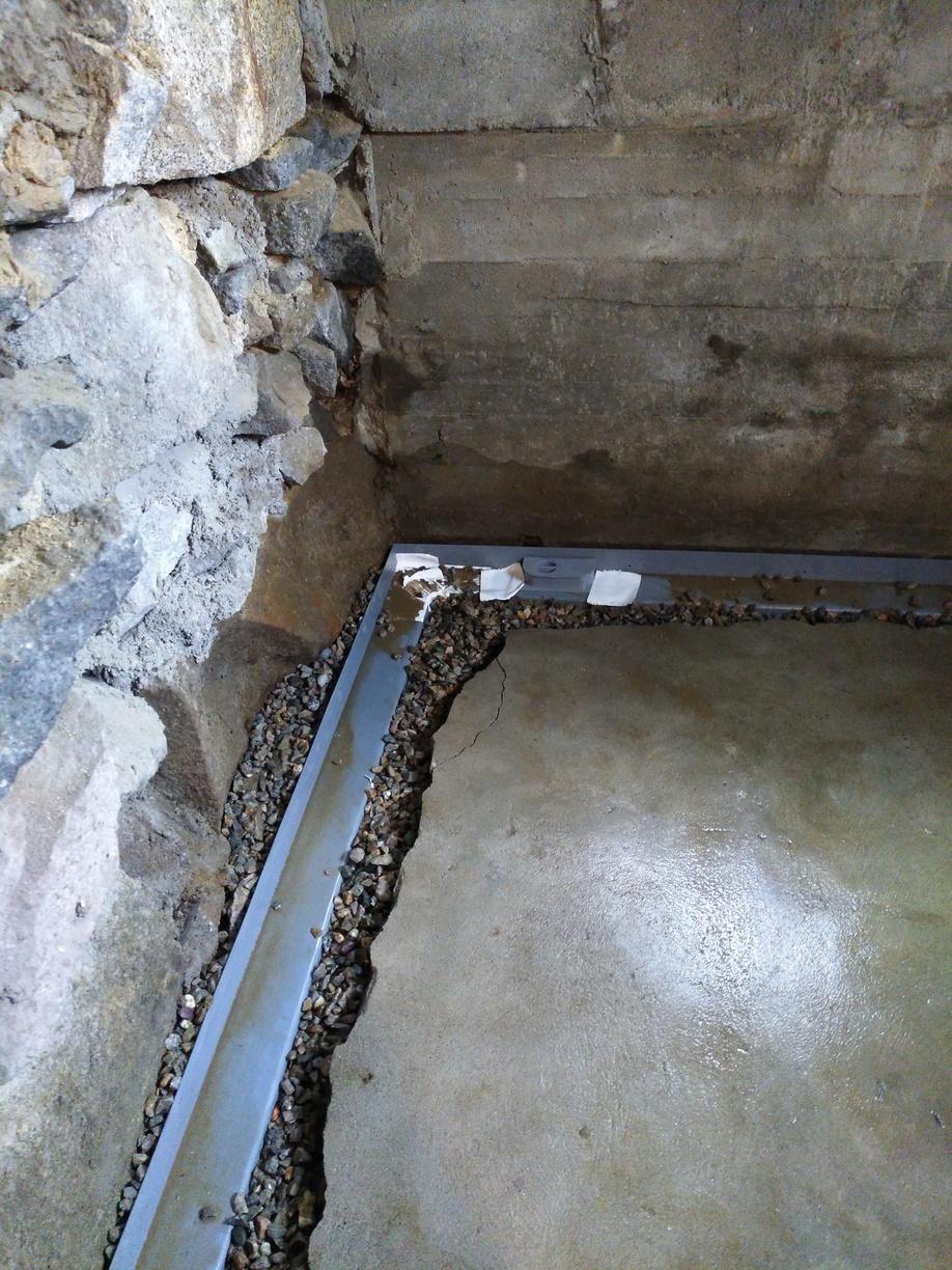 Basement Waterproofing Quincy, MA Water Solution Installing the Drains