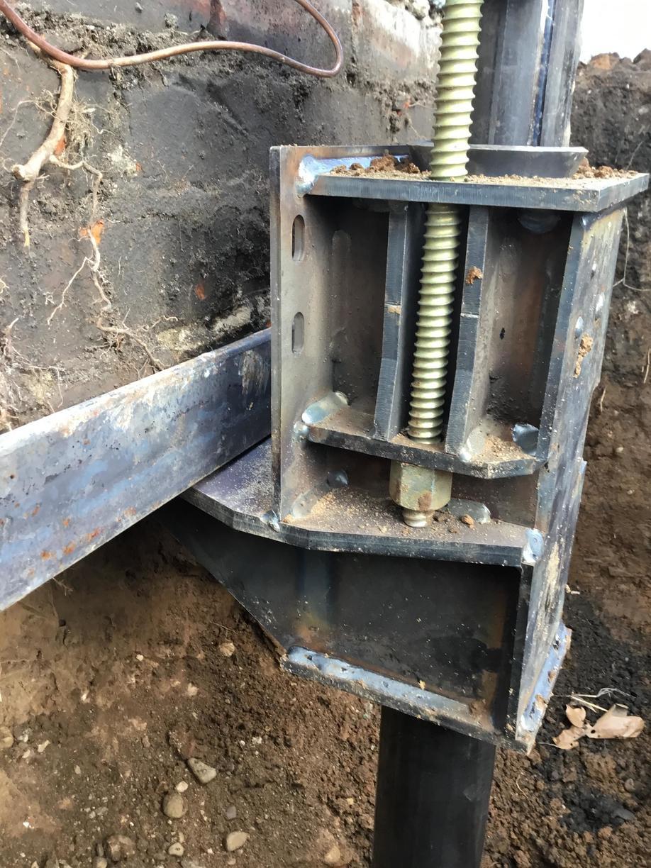 Commercial Foundations Helical Piers are used to stabilize a