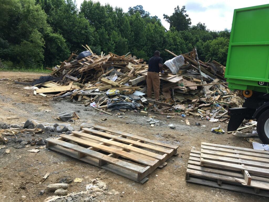 The Junkluggers of East Tennessee Junk Removal Photo Album Clearing Out a Pile of Junk in