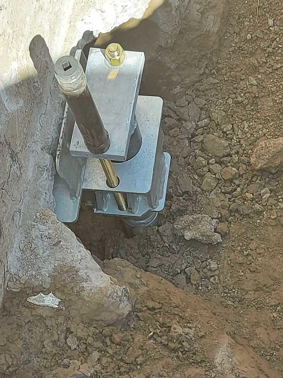 Foundation Repair Helical piers in Caledonia Under Footing bracket.