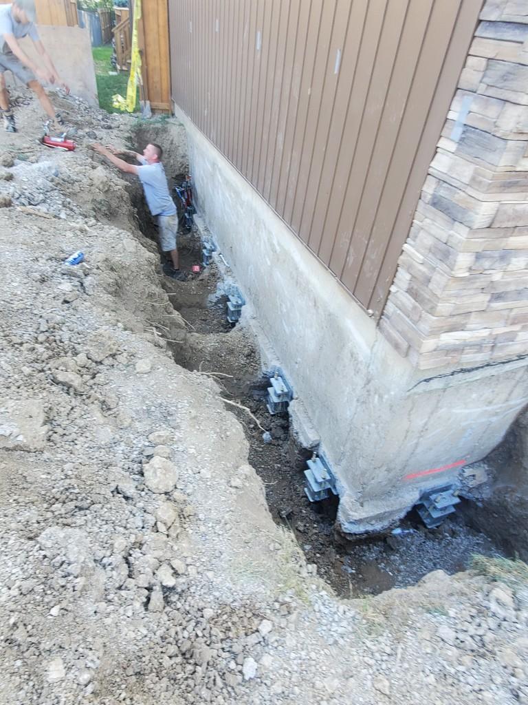 Foundation Repair Helical piers in Caledonia Under Footing Brackets