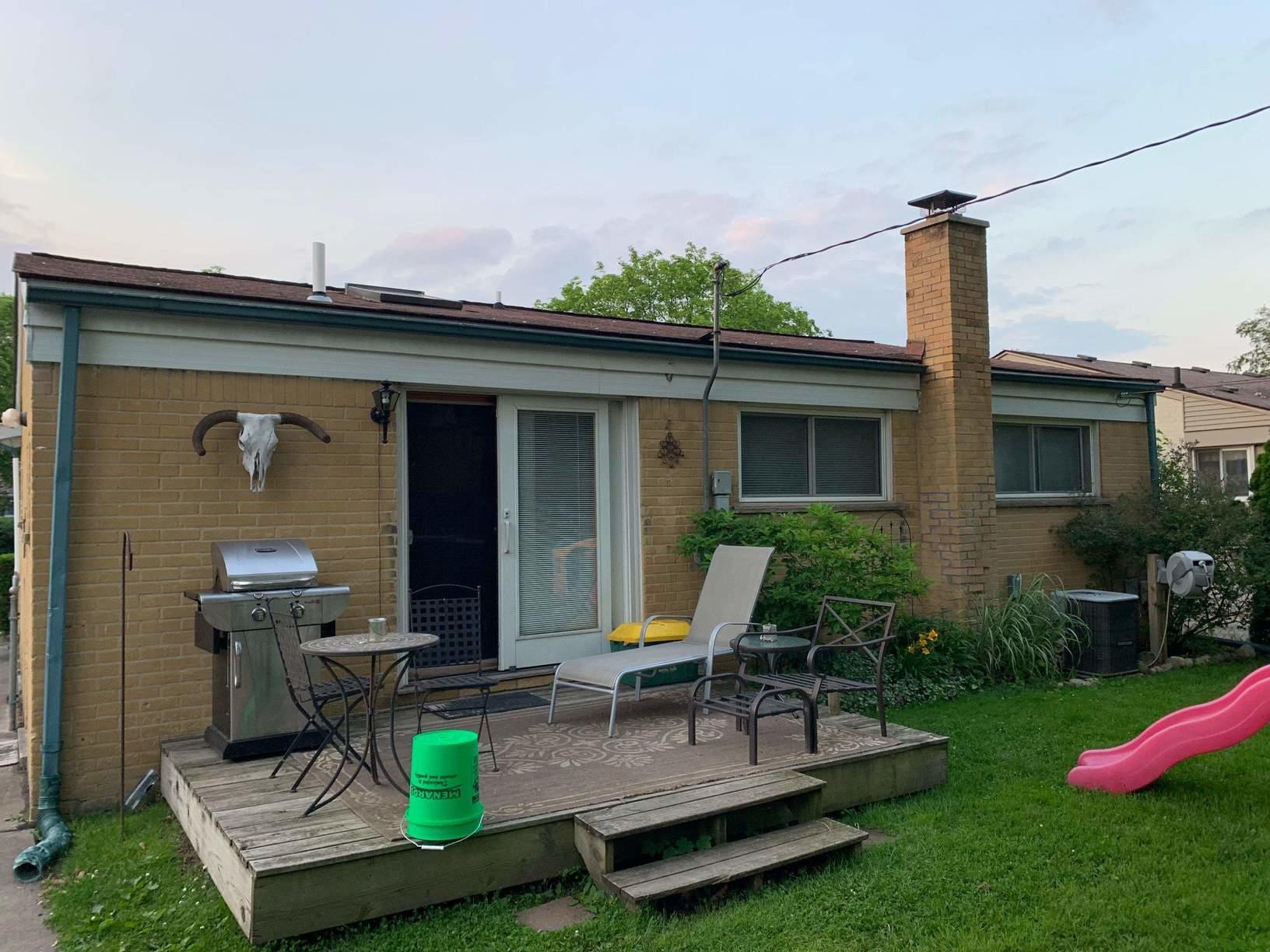 Brick and Aluminum Home Painted with Rhino Shield Back Before