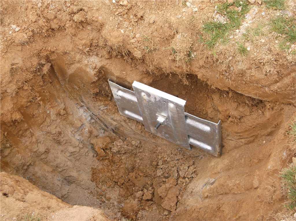 Foundation Repair Wall Anchors Installed to Fix Retaining Wall in