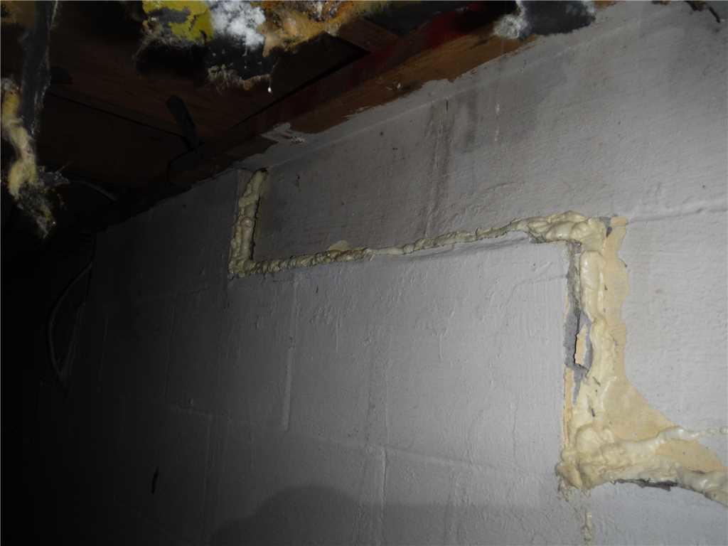 Foundation Repair Charlotte, MI Bowing Block Wall Foundation CloseUp of Spray Foam Crack