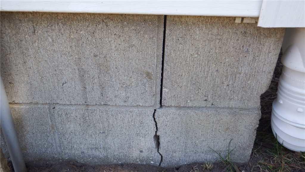 Foundation Repair Fixing a Bowing Wall in Traverse City, MI Cracked Blocks on Exterior Show