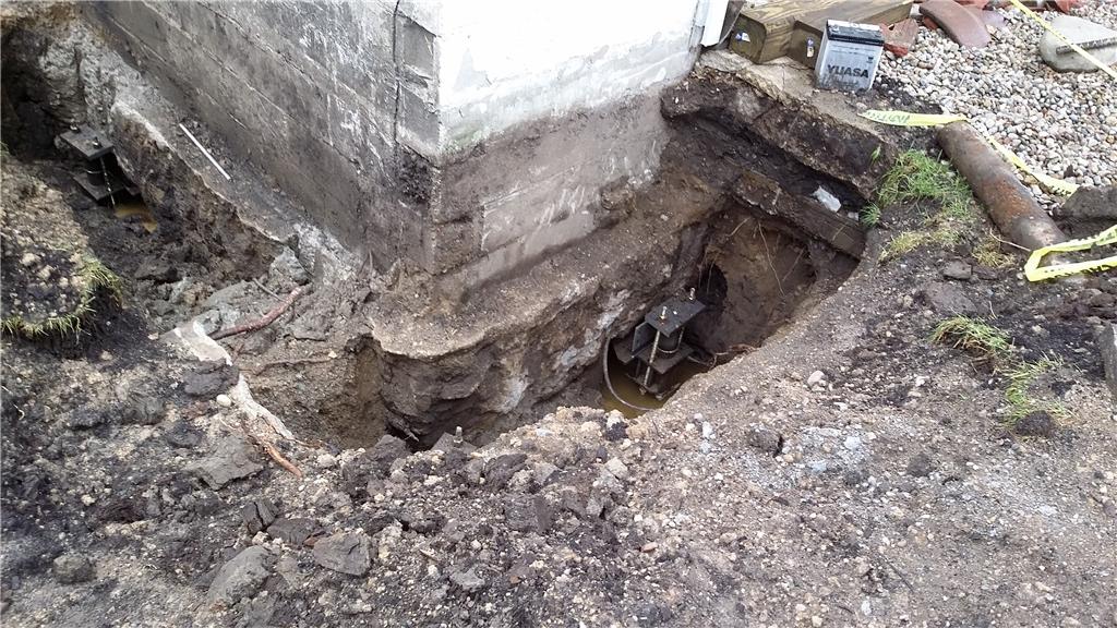 Foundation Repair Stabilizing a Sinking Foundation in East Lansing Pier Installation in Progress