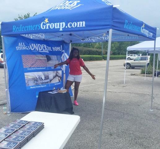 Tinisha Harris holds down the fort in the Redeemers Group booth