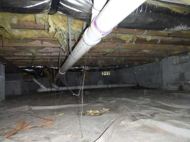 Debris and Moisture Filled Crawl Space