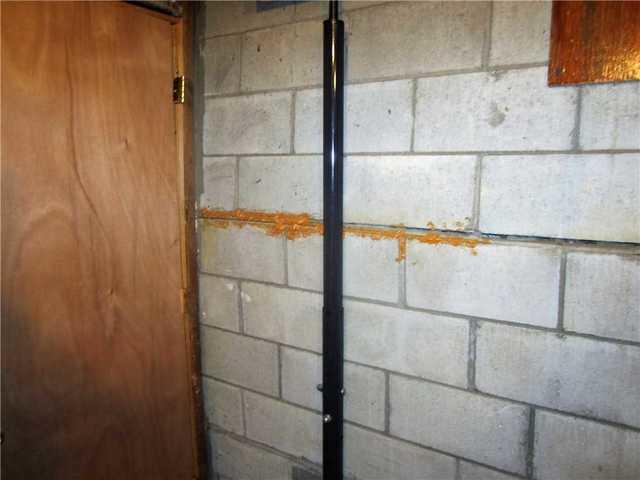 Bowing Wall Threatens Pipes in Basement