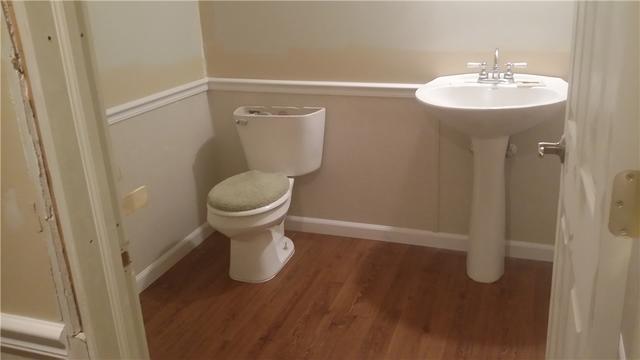 No more shop vac for this bathroom! New waterproof flooring and Everlast panels spruce the place up quite a bit.