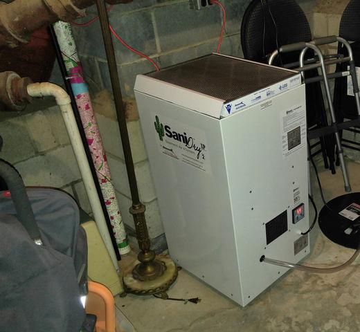 We installed a commercial-grade SaniDry XP dehumidifier. These powerful maintenance-free dehumidifiers are specifically designed to work in basements and crawl spaces. They operate automatically, turning on and off according to a built-in hygrometer. Also, they drain directly into the sump pump, so they never have to be emptied