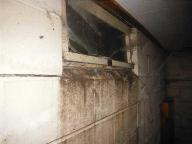 Severe water stains below window, from water that entered through the unsealed window.