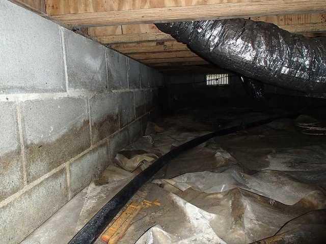 The crawl space in Wittman, MD is filled with moisture, water, and mold. The homeowners need to put down the CleanSpace liner, dehumidifier, TripleSafe sump pump, and water drainage mat.