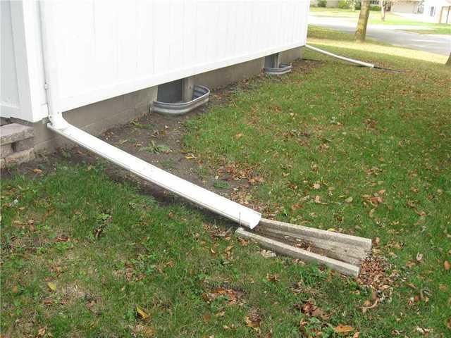 The outside drain is not far enough from the home's foundation. This leads to water pooling around the house and getting into the basement through wall cracks.