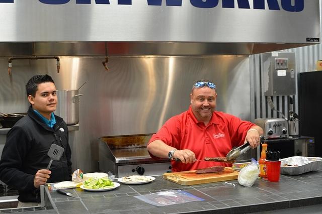 <p>Bill preparing the plate as Martin looks on ...</p>