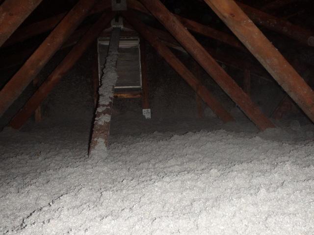 This is how the ruler (middle of the picture) looks now that we have finished. There is now the BPI recommended amount of insulation in this attic, which will keep the house very comfortable this winter.