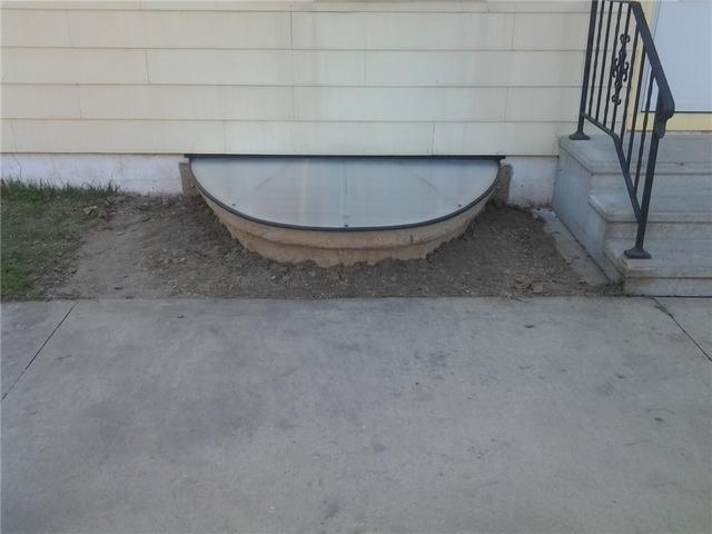 Egress window and SunHouse basement window enclosure installed.