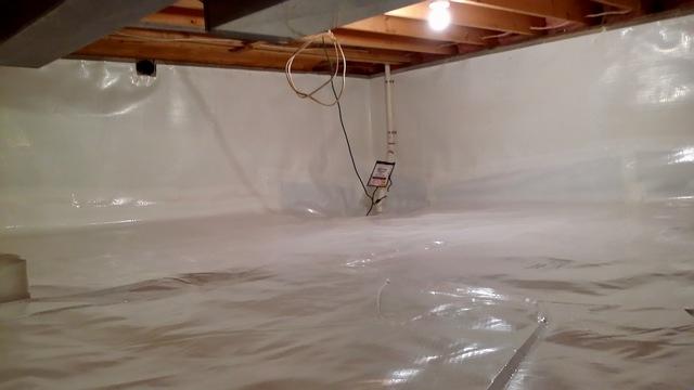 The crew worked to install the entire system so that the sump pump can remove any moisture from the space.