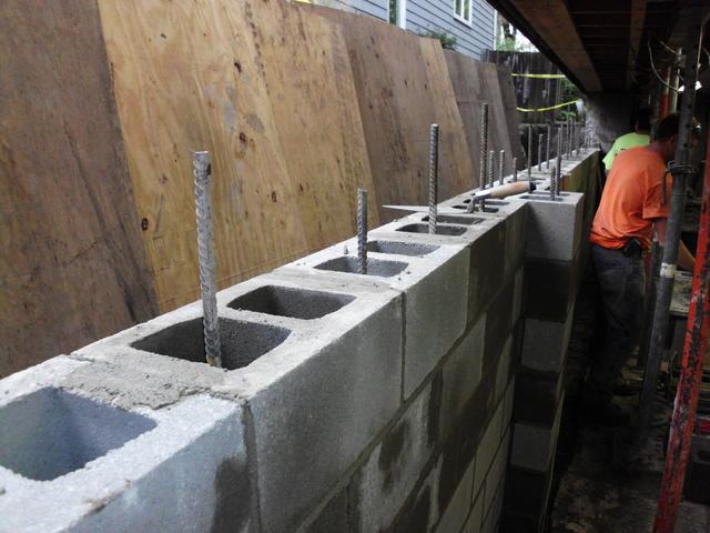 <p>We begin the process of re-building the cinder block wall.</p>