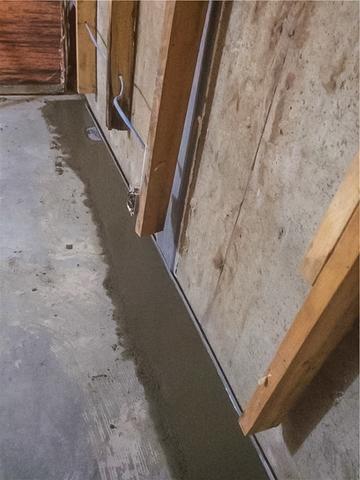 A view inside the basement of the WaterGuard® drainage channel installed and cemented back in place. Once the cement dries the walls can be framed back and the basement can be re-finished.