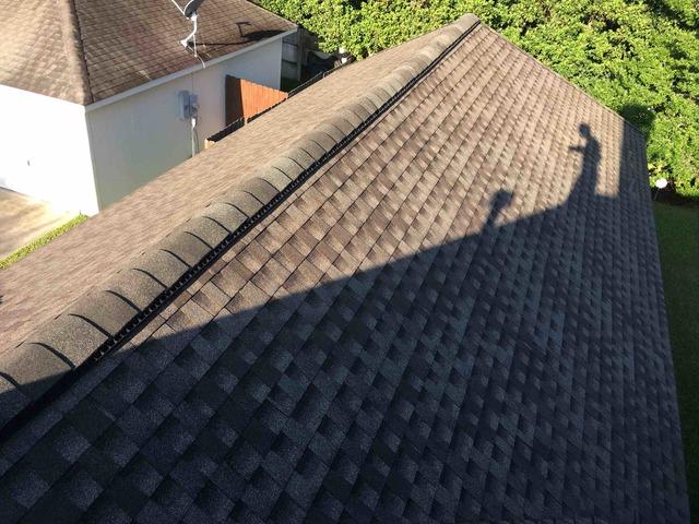 The new roof is done, and the earth tones stand out in this shingle color. This roof is guaranteed to withstand 130 MPH winds. That's up to and including a category 3 hurricane! It is also guaranteed against staining for 10 years.