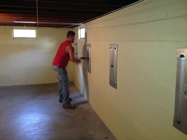 <p>Putting the finishing touches on the <a href="https://www.suredrybasements.com/foundation-repair-wisconsin/foundation-repair-products/wall-anchors.html">anchor</a> plates by torquing them.</p>