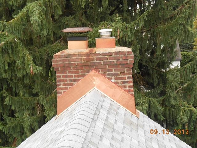 <p>Asphalt roof replacement with a copper chimney flashing in Malvern, PA. We pride ourselves on giving our customers the exact look they want and this is job is a perfect example of that.</p>