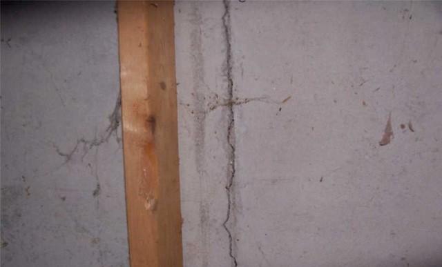 Sometimes walls have a sort of wooden framework installed over them for extra stability - the presence of this crack near one of the vertical supports shows that it isn't enough.