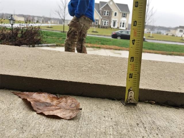 The porch was settling causing a small dip near the front step.