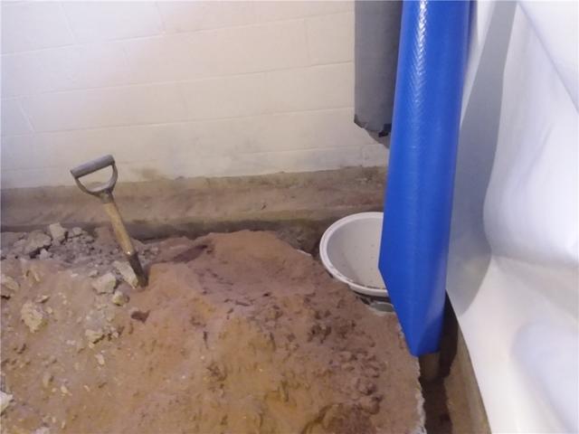 We clear extra space to install a new basin for the sump pump. This is where the new drain tile leads so that the water may be pumped out of the home.