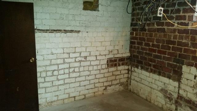 The walls of the basement are stained from the water intrusions.