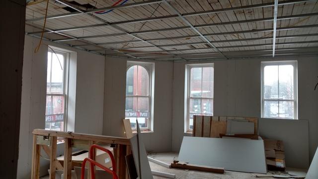 Electric being installed above a drop ceiling in this bright upper floor apartment.