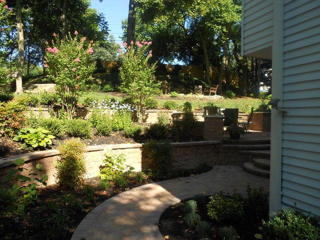 Excellent stonework design creates a path along the sides of the house and to the main patio in the back.