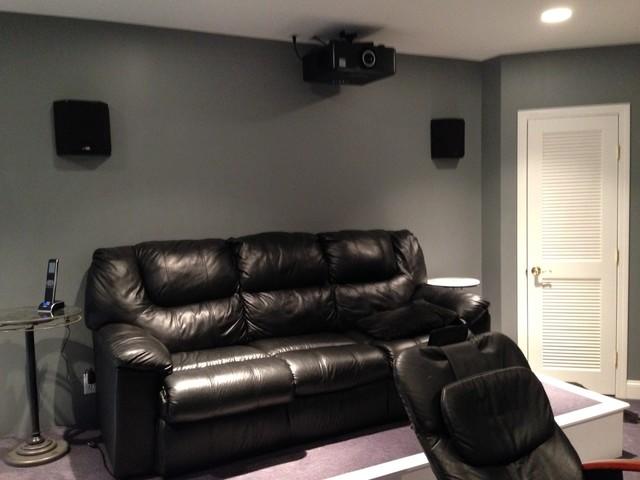 Back of theater room with projector, seating and surround sound