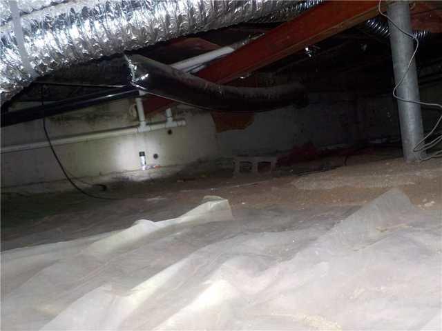 Bless the companies that market this glorified tarp as crawl space protection. It isn't protecting much, and really just adds another 'thing' to get dirty in the crawl space. In order to provide full protection from the dirt floor, the vapor barrier we install is attached in a way that ensures complete coverage.