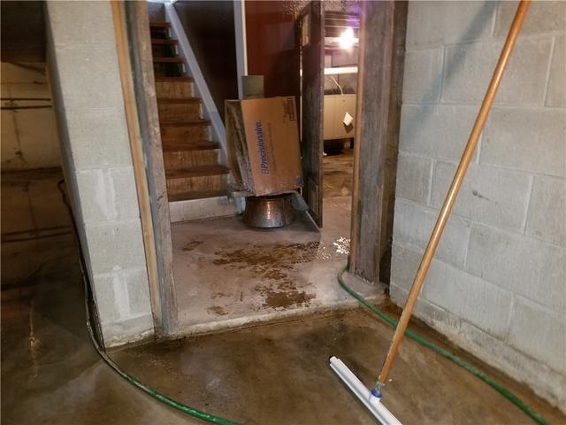 Standing Water Overwhelms Basement and Homeowner