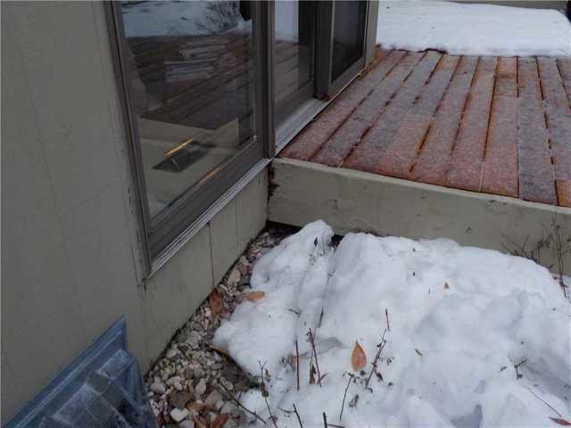 Notice how the snow has melted in the few inches immediately next to the house? That's a sign that the crawl space is losing energy, literally heating the outside. It's natural for the ground to stay thawed close to a house, but this level of melt is indicative of something more.