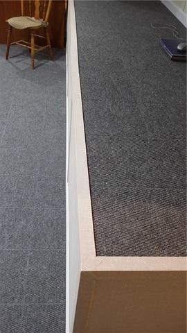 The edges along this carpeted ledge are trimmed out neatly for a clean finished edge.