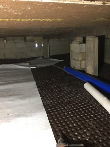 Here you can see the Drain matting under our CleanSpace. Together these products keep the crawlspace dry and create a vapor barrier.