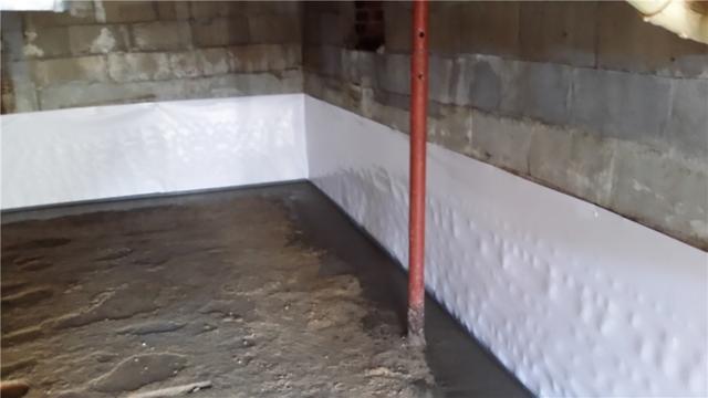 The WaterGuard system is installed right on the home's footing by removing concrete around the base of the all. The area is then filled in with crushed stone and the concrete is replaced with the exception of a small gap along the edge of the all. In this case, our mold-resistant CleanSpace material is installed on the walls to help direct moisture into the drainage system.