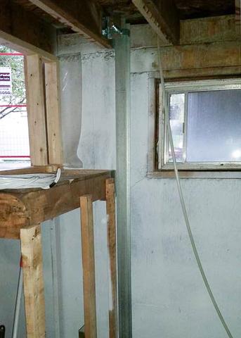 A view of a single PowerBrace™ beam installed near a basement window.