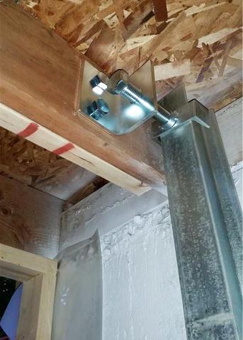 A close up view of a PowerBrace™ beam being secured to the existing floor joist.