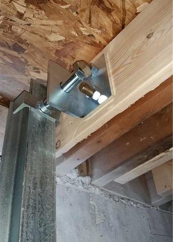 A view at the top of another PowerBrace™ beam where it is secured to the homes existing floor joist.