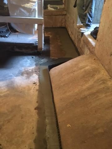 This system effectively re-directs water away from areas where it can cause harm. The water is led through the drain tile into a sump pump where it is pumped away from the building.