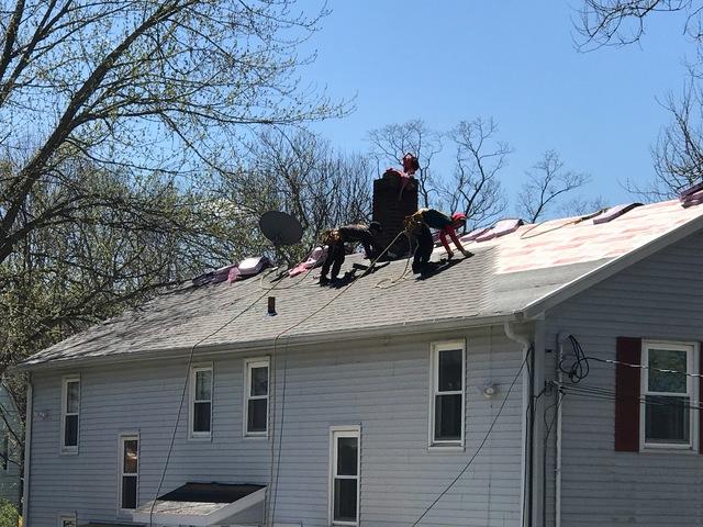 Crew laying the new shingles