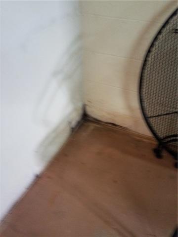 Dark marks on the wall are evidence of water seeping in over time.