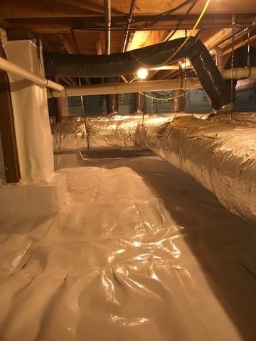 We wrapped the support beams in the crawlspace to keep that dry as well. Maneuvering around ductwork in crawlspaces isn't always easy but the finished product is worth it!