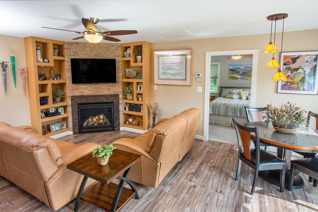 This in-law suite is the epitome of coziness. This lovely living room space gets the added appeal of having a fireplace at its center. Flanked by built in bookshelves, it perfectly combines contemporary design with all the comforts of home.