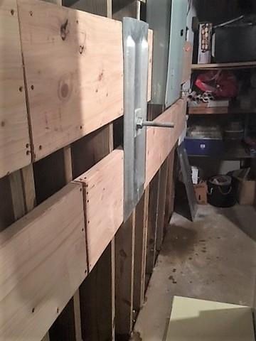Anchors Installed Along Wood Wall